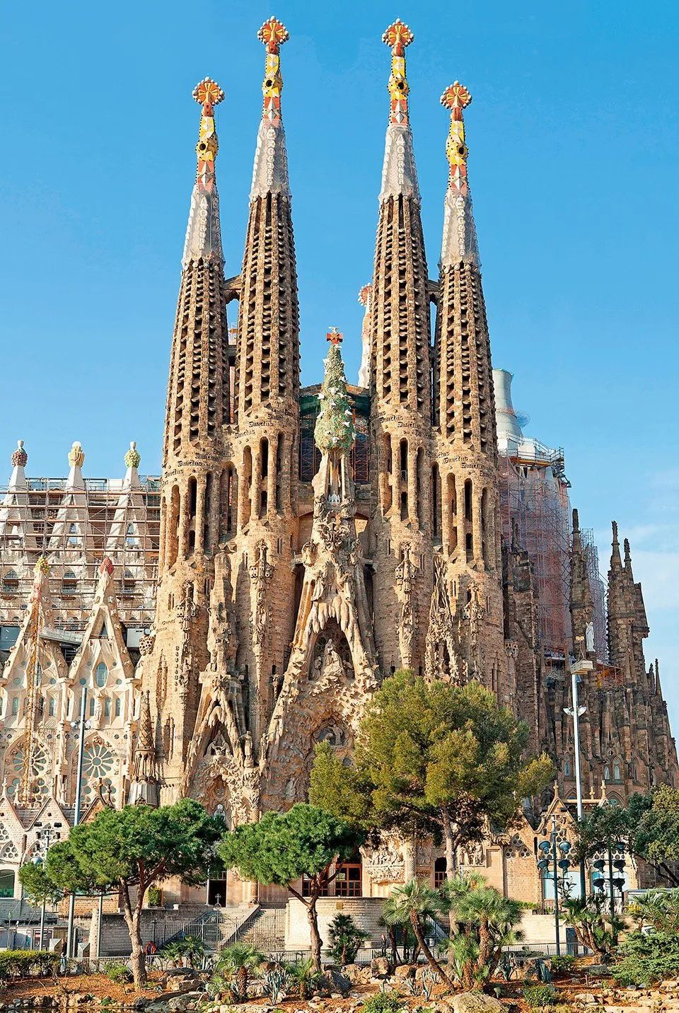 The Nativity façade of the Sagrada Família, with its four towers against a clear sky